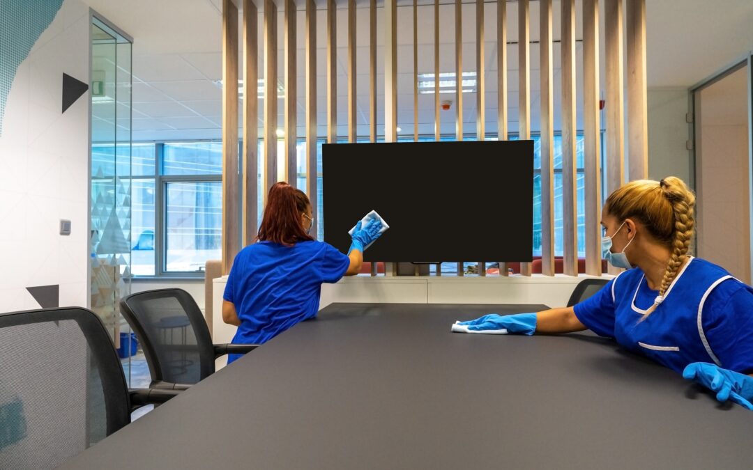 Two,Cleaners,With,Masks,On,Their,Faces,Are,Cleaning,The office cleaning